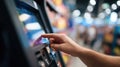 Users hand operating a selfservice payment terminal at a checkout kiosk with the blurred background emphasizing Royalty Free Stock Photo