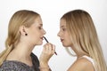 She uses lipliner on her girlfriend Royalty Free Stock Photo
