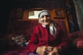 Ushguli, Georgia - June 12, 2014: Elderly Georgian woman sitting at her house in the Caucasus Mountains village