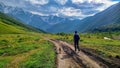 Ushguli - A man and a dog walking on a trail in the Greater Caucasus Mountain Range in Georgia. Royalty Free Stock Photo