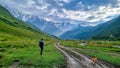 Ushguli - A man and a dog walking on a trail in the Greater Caucasus Mountain Range in Georgia. Royalty Free Stock Photo