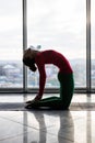 Ushtrasana. Beautiful yoga woman practice in a big window