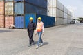 Usiness Logistics import export shipping concept. Foreman and cargo container worker walk in workplace area