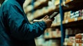 Using an AI-driven inventory management system on a handheld device, a retail worker ensures shelves are stocked with