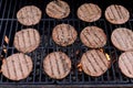 Using a barbecue flame grill, beef meat barbecue burgers for hamburgers are prepared Royalty Free Stock Photo