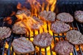 Using the bbq fire flame grill for the grilling of grilled beef meat barbecue burgers for hamburgers Royalty Free Stock Photo