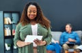 Using the best apps for the best results. a young businesswoman using a digital tablet with her team in the background. Royalty Free Stock Photo