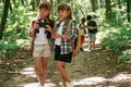 Using binoculars. Kids in forest at summer daytime together Royalty Free Stock Photo