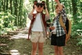 Using binoculars. Kids in forest at summer daytime together Royalty Free Stock Photo