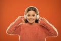 Using bluetooth wireless technology. Little child listening to music in bluetooth stereo earphones. Small girl wearing Royalty Free Stock Photo