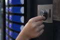 Using coffee vending machine. Girl inserting coin into acceptor, closeup