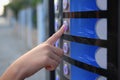 Using coffee vending machine. Woman pressing button to choose drink, closeup Royalty Free Stock Photo