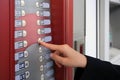 Using coffee vending machine. Woman pressing button to choose drink, closeup Royalty Free Stock Photo