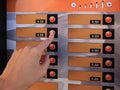 Using coffee vending machine. Woman pressing button to choose drink, closeup Royalty Free Stock Photo