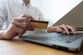 Using a credit card to pay online, use a smartphone for online shopping, a male hand holds a credit card Royalty Free Stock Photo