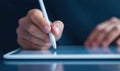 Using a digital pen on a tablet, a hand interacts with technology for creative or business tasks. Royalty Free Stock Photo