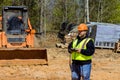 Using drone, construction inspector checks quality of construction at a construction site Royalty Free Stock Photo