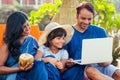 Using eco metal recyclable tube.happy asian parents and cute girl enjoying summer vacation in Goa beach , drinking Royalty Free Stock Photo