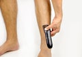 Using electric razor on legs Royalty Free Stock Photo