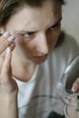 Using face cream. Beautiful woman is applying moisturizing gel. Close-up portrait Royalty Free Stock Photo