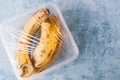 Using food film for bananas storage in fridge. Top view Royalty Free Stock Photo