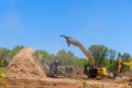 Using forestry mulcher, we loaded roots from trees to an industrial shredder machine that chopped a wooden Royalty Free Stock Photo