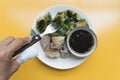 Using a fork to go to Fried Chinese Chive Dumplings inside Taro and Vegetables Served with Sweet Black Soy Sauce on dish. yellow Royalty Free Stock Photo