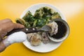 Using a fork to go to Fried Chinese Chive Dumplings inside Taro and Vegetables Served with Sweet Black Soy Sauce on dish. yellow Royalty Free Stock Photo