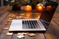 Using a gold card, a hand shops online with a laptop on a wooden table