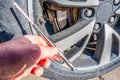 Using a hand guage to check tire pressure Royalty Free Stock Photo