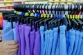 Using hand to choose a set of clothes wear by colour and size