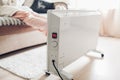 Using heater at home in winter. Woman warming her feet. Heating season Royalty Free Stock Photo