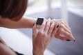 Using her smartwatch at home in the living room Royalty Free Stock Photo