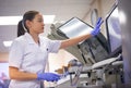 Using high quality equipment to find a cure. a young scientist using a computer to conduct a medical test in a