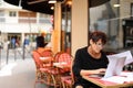 tired female employee of bank adds financial plan in laptop