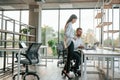 Using laptop. Man and woman are working in the modern office together Royalty Free Stock Photo