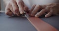 Using leather edge beveler during belt manufacturing process close-up