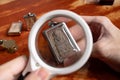 Using a magnifying glass to see the detail on an old Thai Buddha amulet Royalty Free Stock Photo