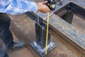 Using a measuring tape to measure the dimension of steel structure work Royalty Free Stock Photo