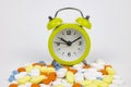 Using medicines in time concept. Clock on the pills isolated on white background Royalty Free Stock Photo