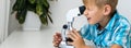 Using microscope. Children plays a scientists in lab by using equipment. Royalty Free Stock Photo