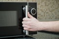 Using microwave oven in the kitchen, close up photo Royalty Free Stock Photo