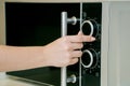 Using microwave oven in the kitchen, close up photo Royalty Free Stock Photo
