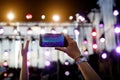 Using a mobile phone at outdoor music festival Royalty Free Stock Photo