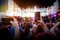 Using a mobile phone at outdoor music festival Royalty Free Stock Photo