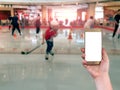 using mobile smart phone with Ice skating blur background,Vintage filter Royalty Free Stock Photo