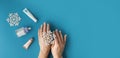 Using moisturizing hand cream during winter season. Female hands smearing white cream on the blue background next to different Royalty Free Stock Photo