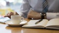 Using moment to make some notes. Confident mature man writing something in his note pad while sitting at the table Royalty Free Stock Photo