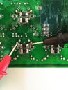 Using multimeter probes to examine a PCB