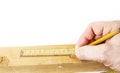 Using old yellow folding meter to measure wood to cut Royalty Free Stock Photo